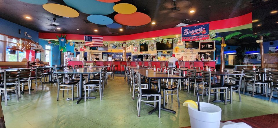 Seafood restaurant dining room with tables and bar seating.