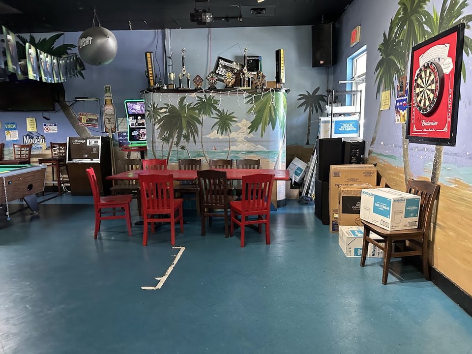 Casual interior with booths, stools, and warm lighting.
